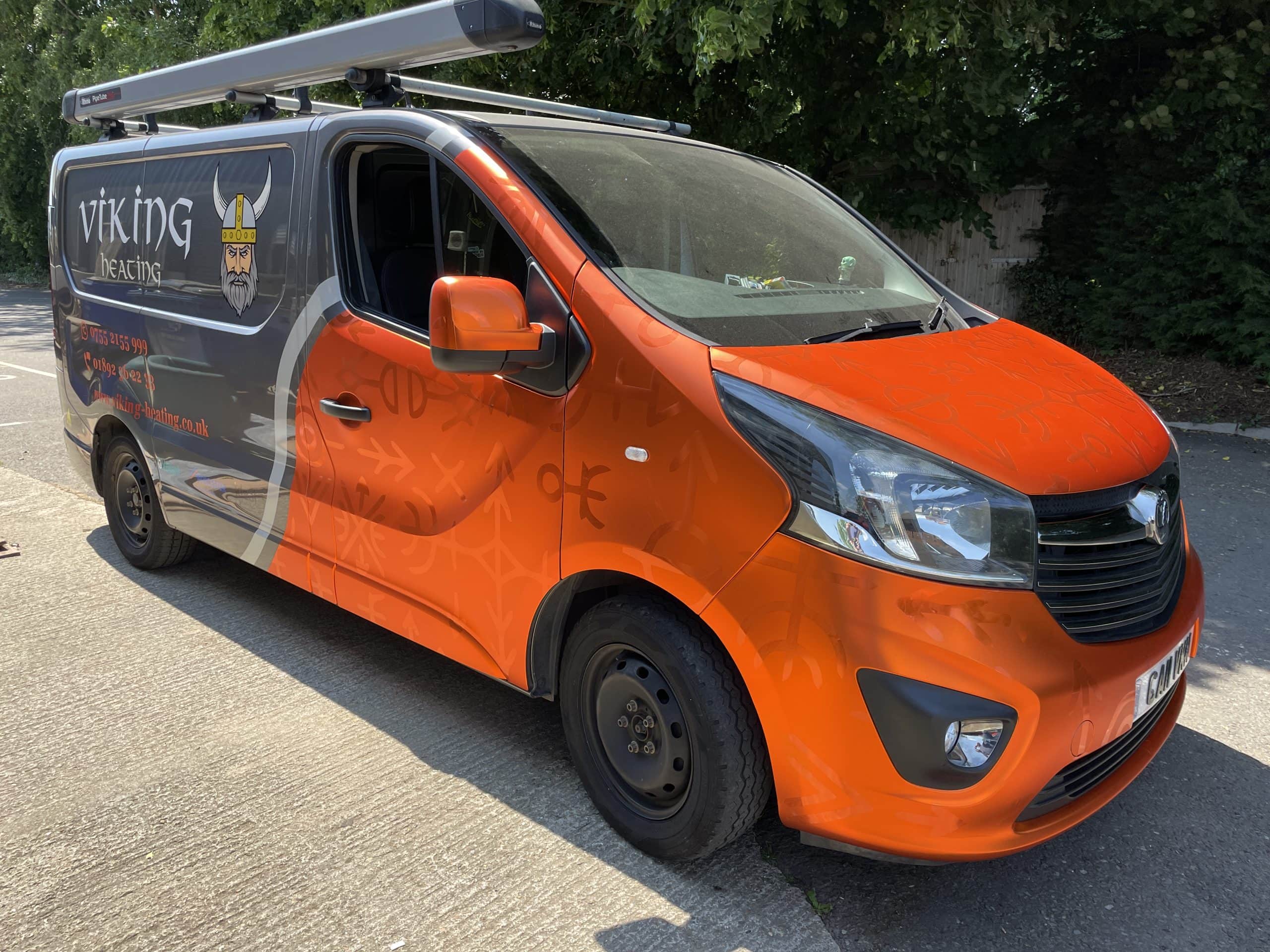 Orange van parked on road with a sign "Viking Heating"