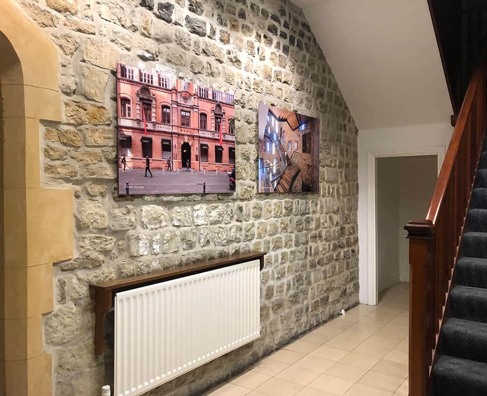 Two pictures are hanging on a wall